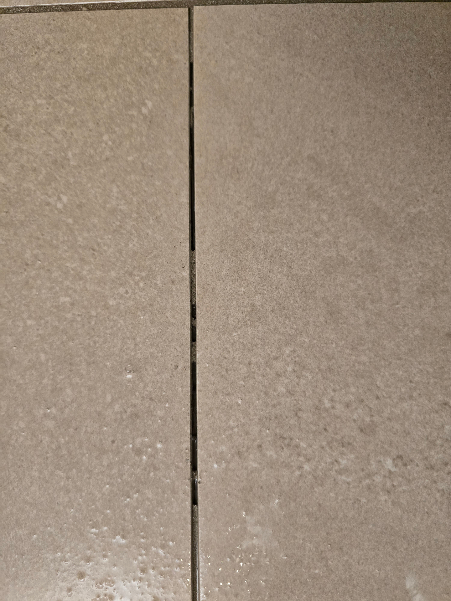 Crumbling grout joint on a new-build East Valley shower showing why grout repair is quoted differently from color sealing in Arizona homes