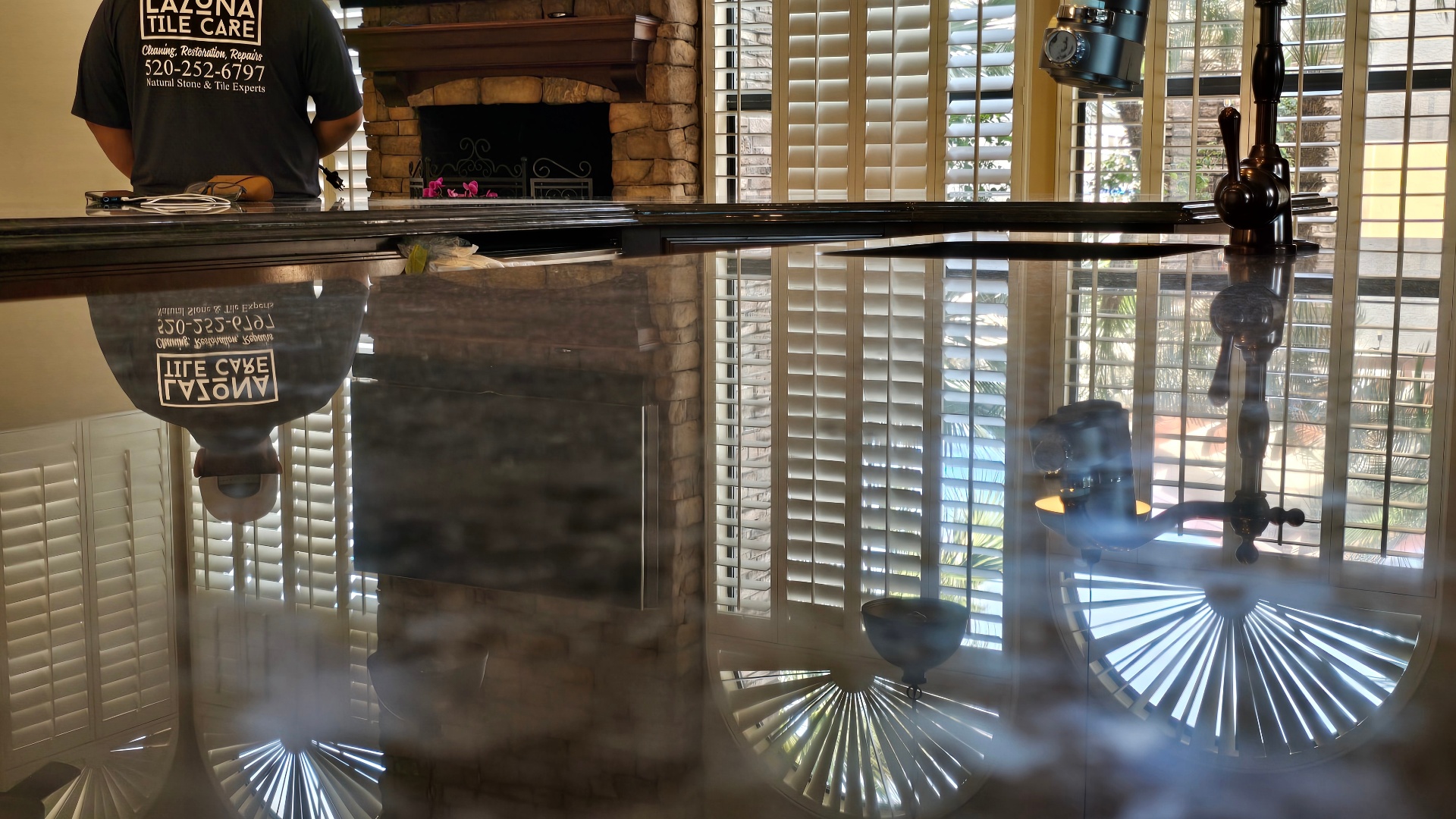 Close-up of travertine countertop showing mirror-like reflection after chemical polishing in Ahwatukee